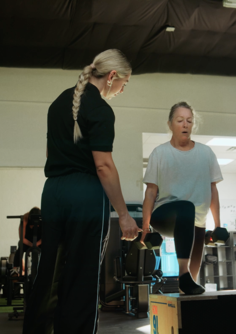 A Trainr coach working with a client on the gym floor